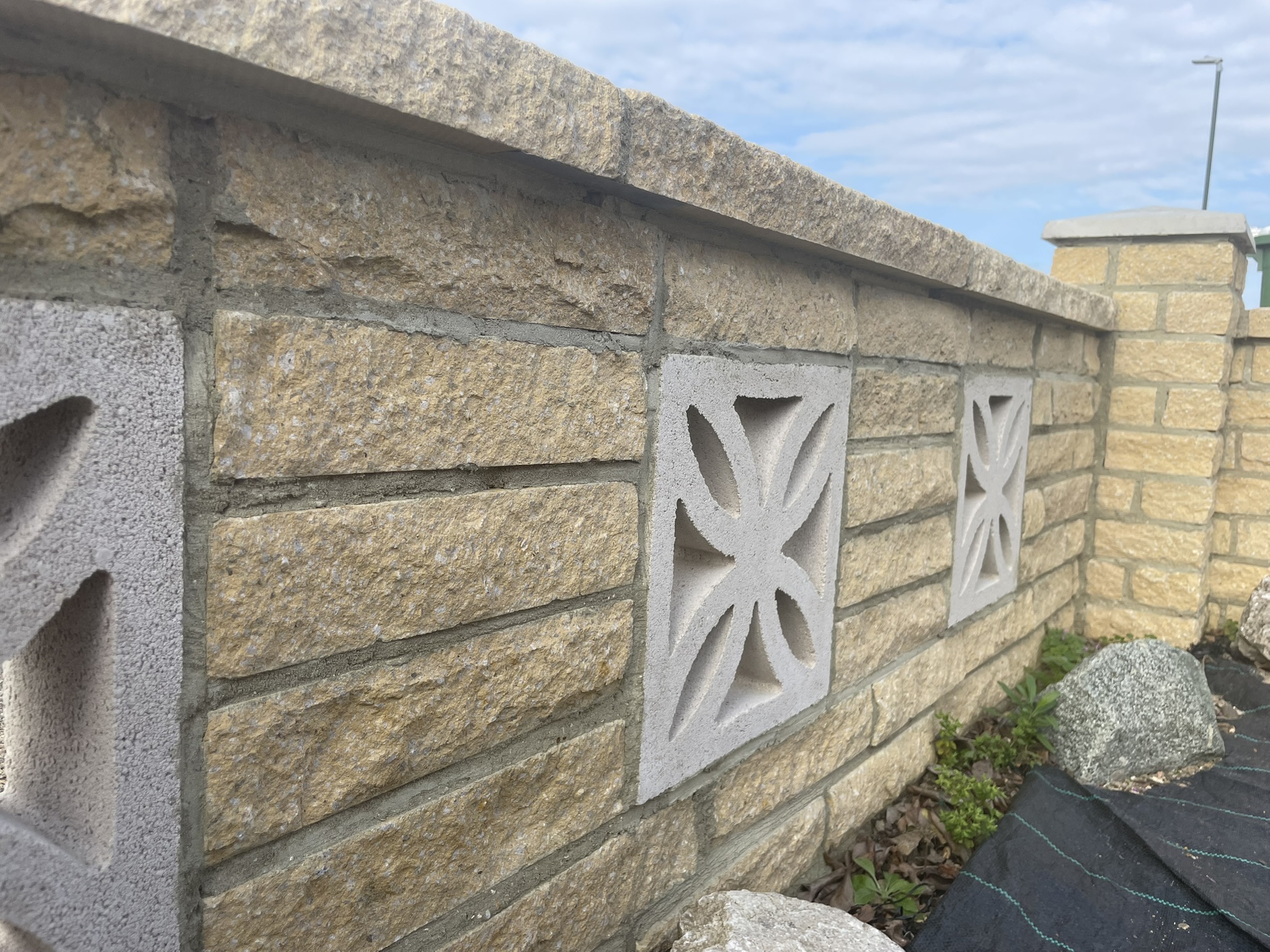 Close-up detail of decorative concrete inset panels on reconstituted stone garden wall by KDB Home Solutions