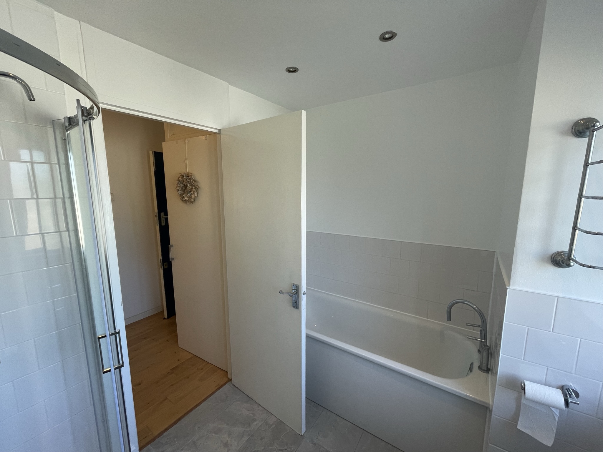 Family bathroom with white subway tiles, inset bath and separate shower enclosure by KDB Home Solutions