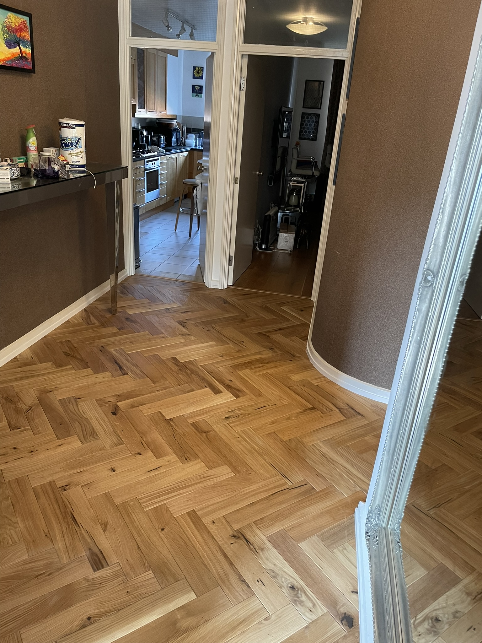 Completed herringbone oak parquet flooring in hallway and living area by KDB Home Solutions