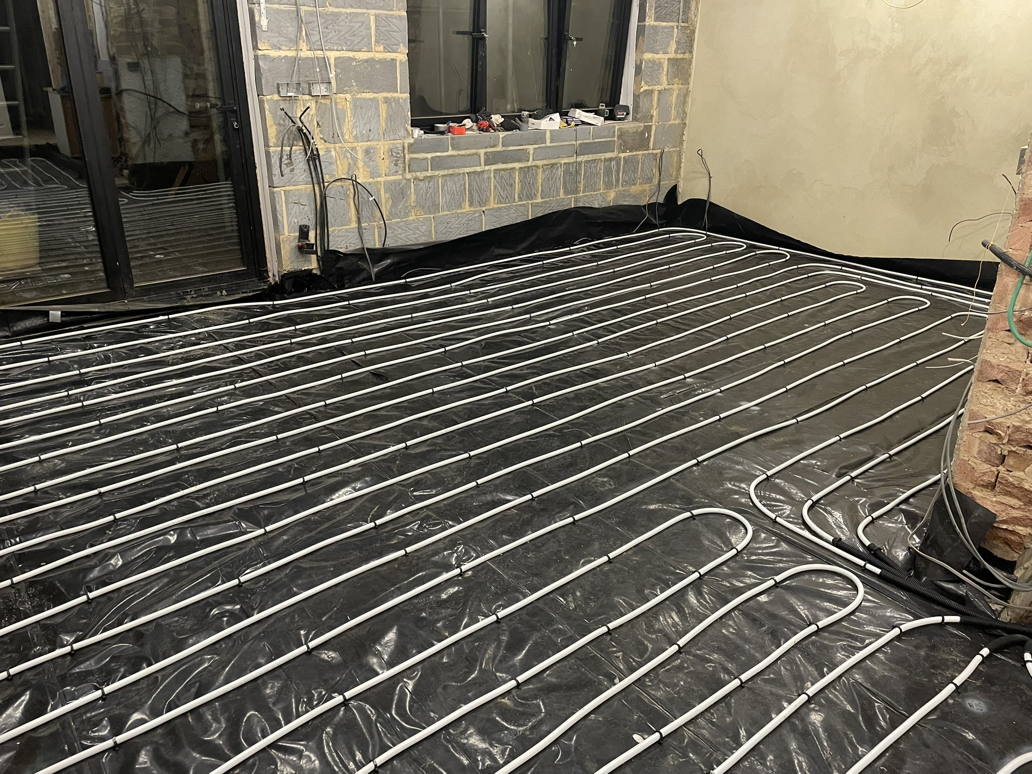 Underfloor heating pipe system laid across extension floor prior to concrete screed by KDB Home Solutions