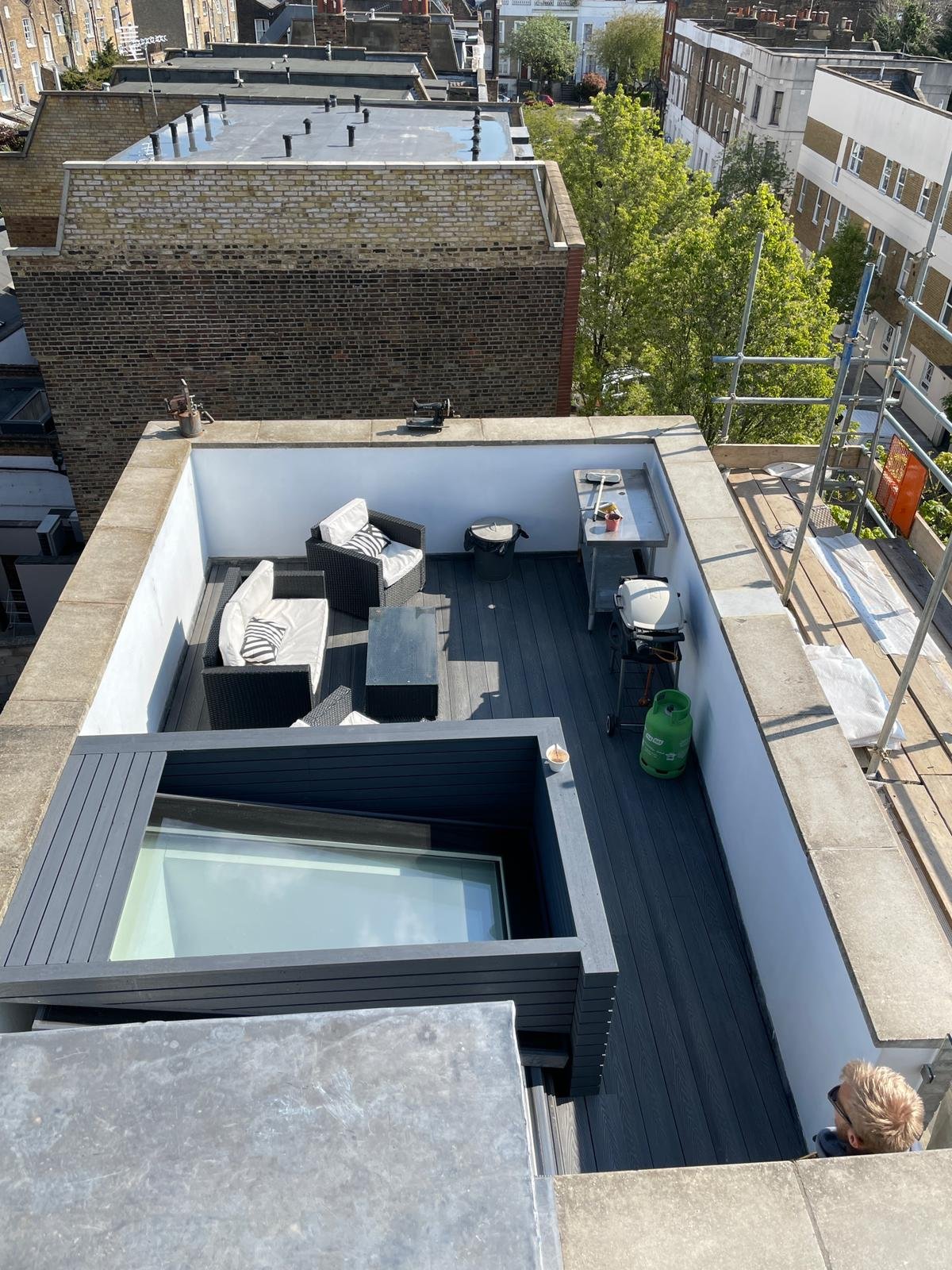 Completed rooftop terrace with composite decking, outdoor seating area and panoramic London views by KDB Home Solutions